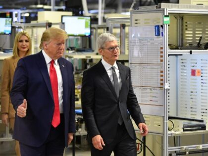 Donald Trump flashes a thumbs up next to Tim Apple