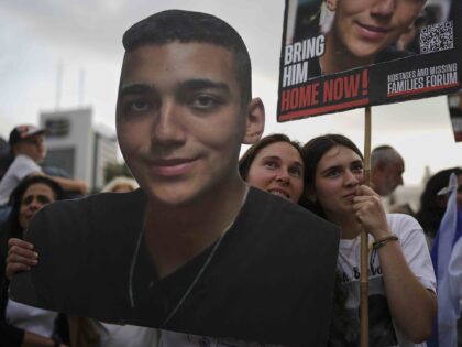 People watch a live broadcast of Israeli-American soldier Edan Alexander as he is released