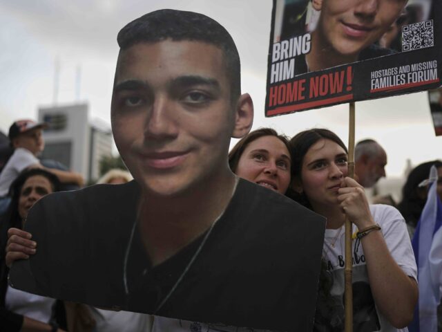 People watch a live broadcast of Israeli-American soldier Edan Alexander as he is released