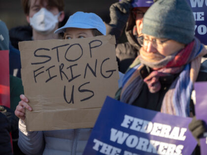 Demonstrators rally in support of federal workers outside of the Department of Health and