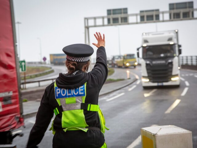 Police manage freight lorry drivers as the French border closures due to a new strain of C