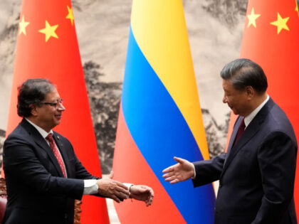 BEIJING, CHINA - OCTOBER 25: Chinese President Xi Jinping (R) shakes hands with Colombian