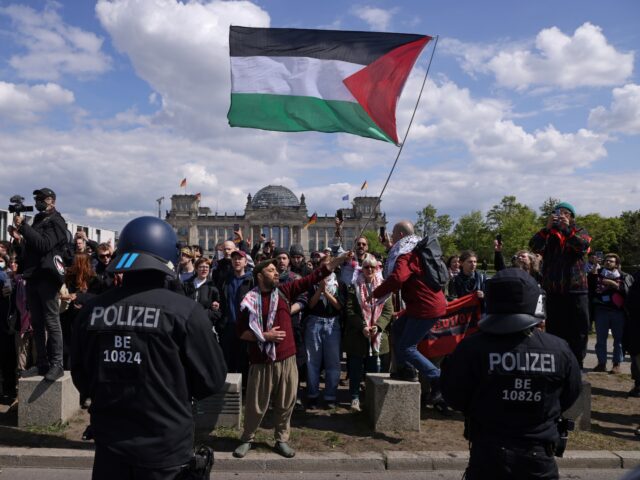 BERLIN, GERMANY - APRIL 26: Police confront protesters, one of whom is waving a Palestinia