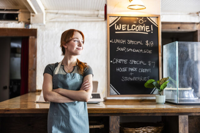 Portrait of young male crepe shop owner in restaurant