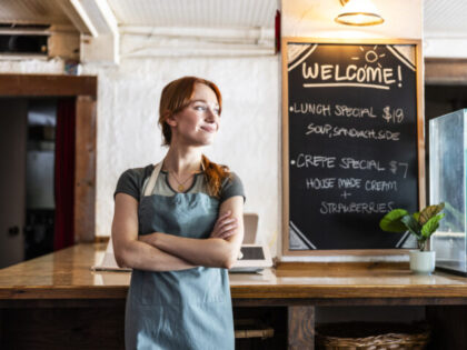 Portrait of young male crepe shop owner in restaurant