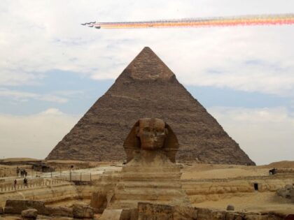 J-10 fighter jets of China's Bayi Aerobatic Team fly over the Giza Pyramids scenic spot in
