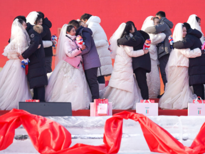 HARBIN, CHINA - JANURY 06: Newly-wed couples holding the mascots "Binbin" and "Nini" of th