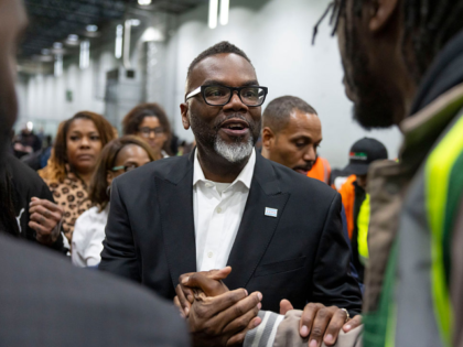 Chicago Mayor Brandon Johnson greets violence interrupters as community leaders gathered t