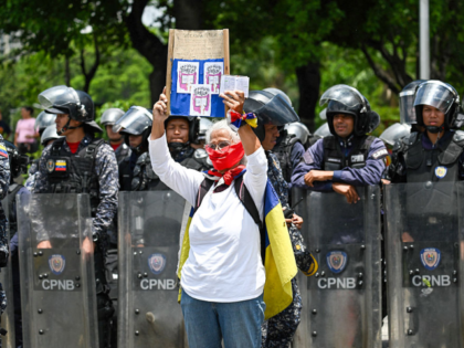 An opponent of the government of Venezuela's President Nicolas Maduro demonstrates in fron
