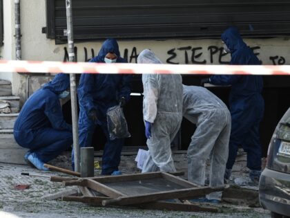Greek police experts search for evidence after a bomb explosion in Thessaloniki on May 3,