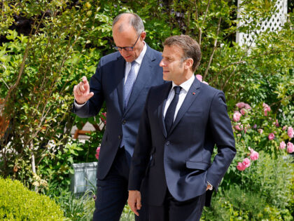 France's President Emmanuel Macron (R) speaks with Germany's newly elected Chanc
