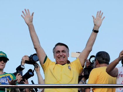 Brazil's former President (2019-2022) Jair Bolsonaro waves at supporters during a march to