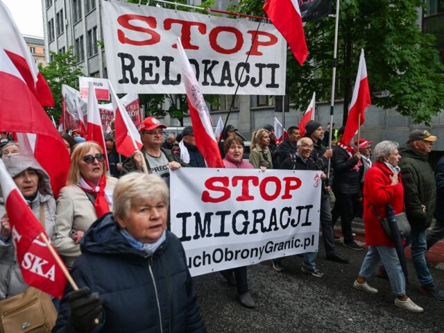 WARSAW, POLAND - MAY 10: People hold banners and the Polish national flag during an anti i