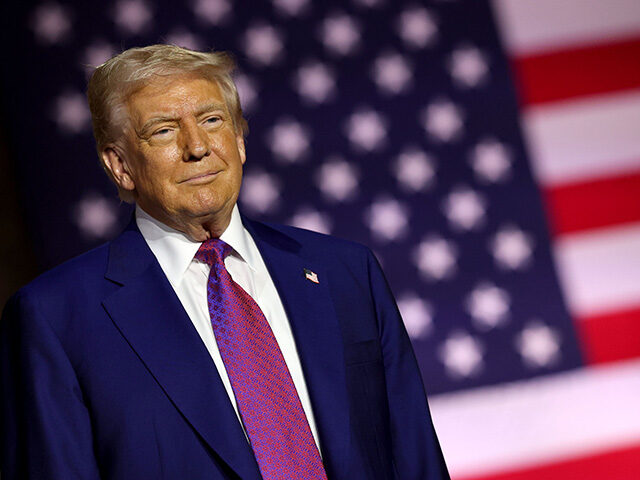 U.S. President Donald J. Trump stands on stage as he tours the Al Udeid Air Base on May 15