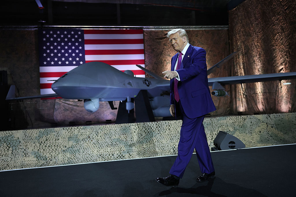 DOHA, QATAR - MAY 15: U.S. President Donald J. Trump gestures on stage as he tours the Al Udeid Air Base on May 15, 2025, in Doha, Qatar. Trump is on the third day of his visit to the Gulf to underscore the strategic partnership between the United States and Qatar, focusing on regional security and economic collaboration. (Photo by Win McNamee/Getty Images)