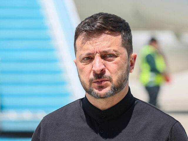 Ukrainian President Volodymyr Zelensky looks on after disembarking from a plane upon his a