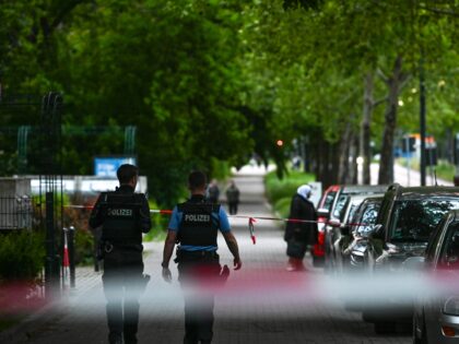 18 May 2025, Saxony-Anhalt, Halle (Saale): Police officers walk along the scene. There was