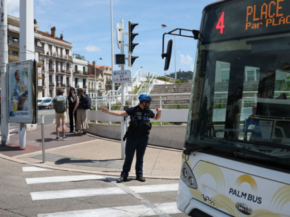 A municipal police officer directs traffic as traffic lights no longer function after a po
