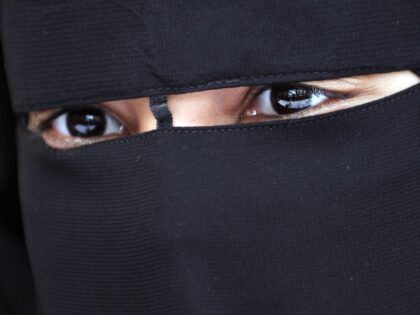 A Muslim woman wearing the niqab (veil which covers the body and leaves only a small strip