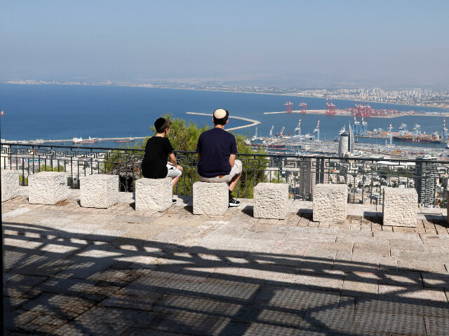 Haifa Israelis sit overlooking the port of Haifa in northern Israel on October 14, 2024, amid th
