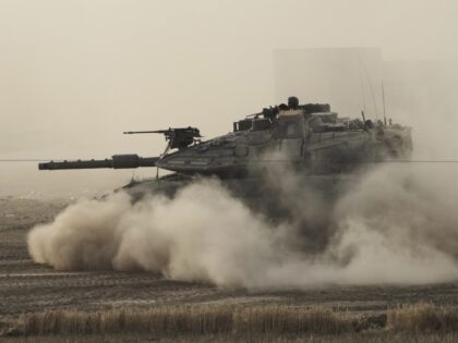 An Israeli tank moves in a staging area in southern Israel, near the border with Gaza, Fri