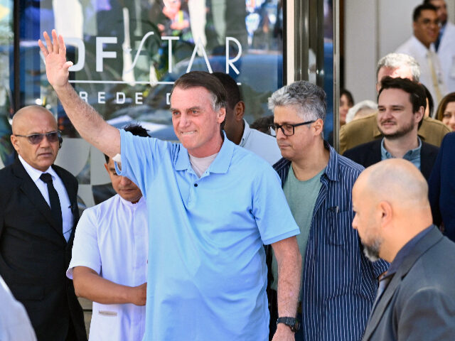 Brazil's former President Jair Bolsonaro waves to supporters as he leaves the DF Star