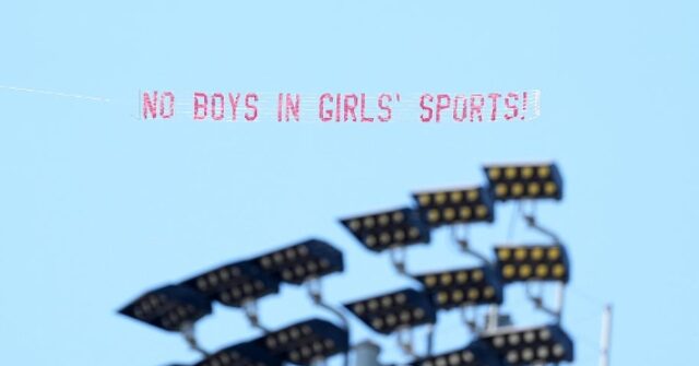 Aerial Banner Saying, 'No Boys in Girls' Sports' Flies over Track Meet