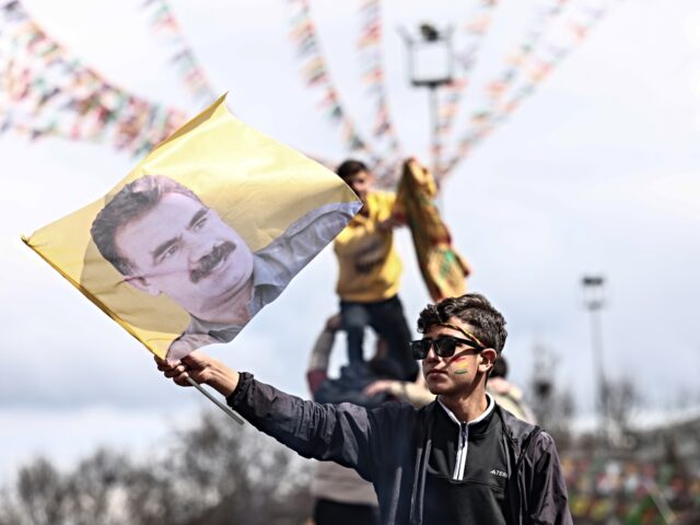 DIYARBAKIR, TURKEY - MARCH 21: A Kurdish youth holds a poster of jailed PKK militant group