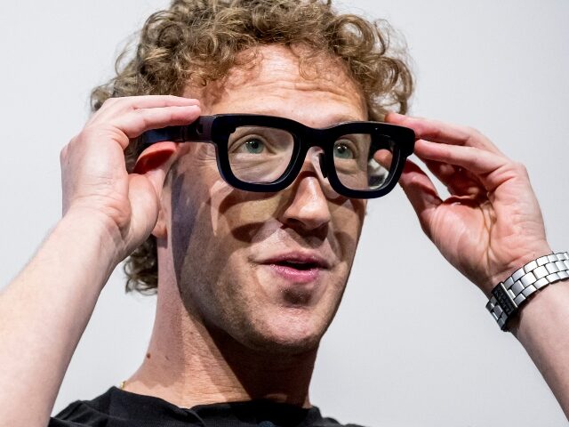 Mark Zuckerberg adjusts his dorky glasses
