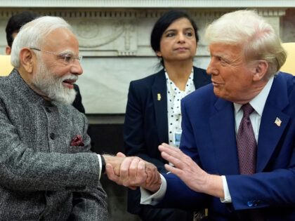 President Donald Trump shakes hands with India's Prime Minister Narendra Modi in the