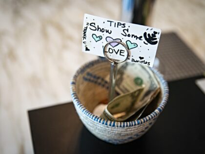 A tip jar at a coffee shop in the Union Market district in Washington, DC, US, on Friday,