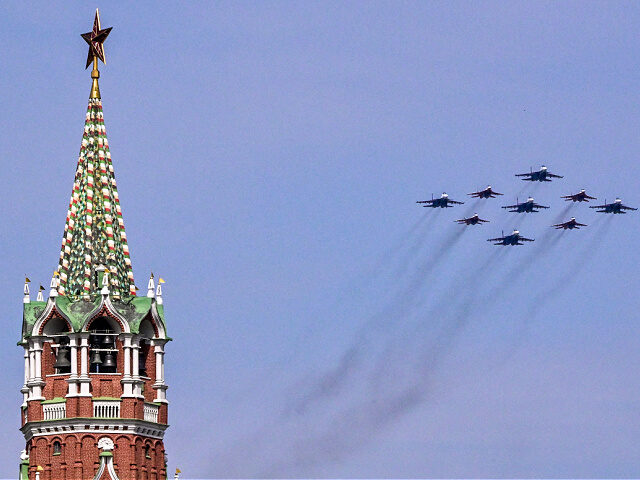 Russian Sukhoi Su-30SM fighter jets and MiG-29 fighter jets fly over Red Square during the