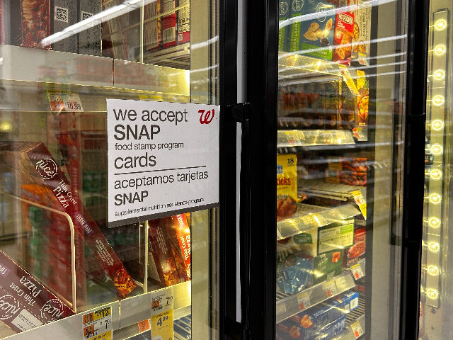 Bilingual sign on door of frozen food aisle, We accept SNAP food stamp cards, Walgreens, Q