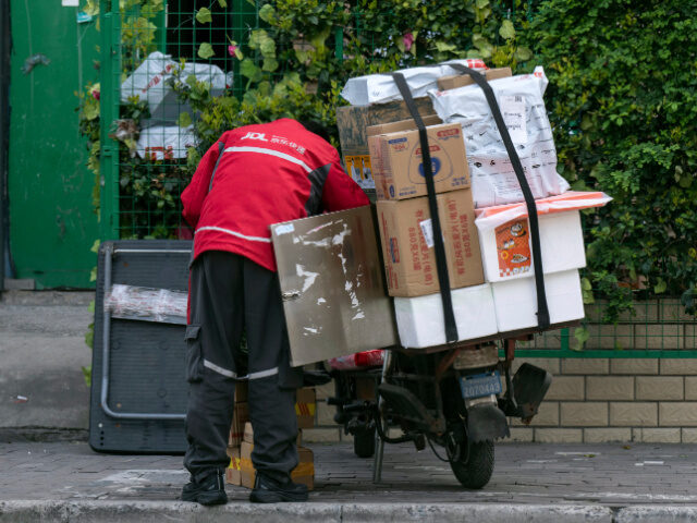 A delivery worker for JD.com Inc. sorts parcels in Shanghai, China, on Friday, April 4, 20