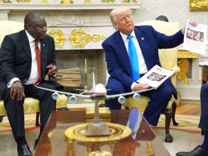 President Donald Trump shows documents as he meets South Africa's President Cyril Ram