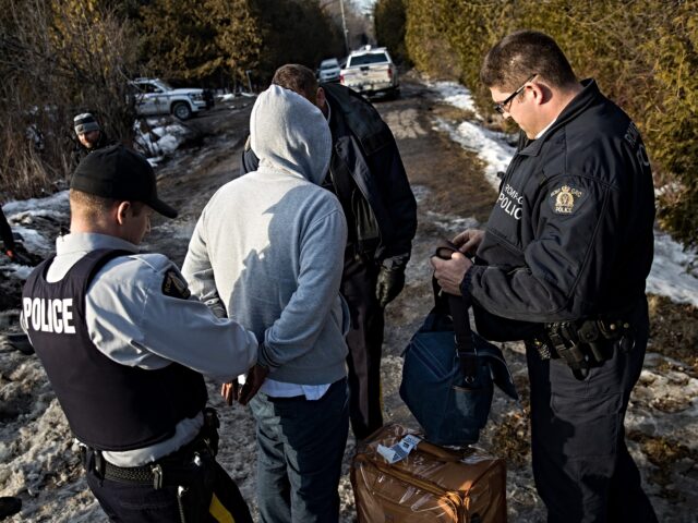 canadian border HEMMINGFORD, QUEBEC - FEBRUARY 22: A man claiming to be from Sudan is apprehended by Royal
