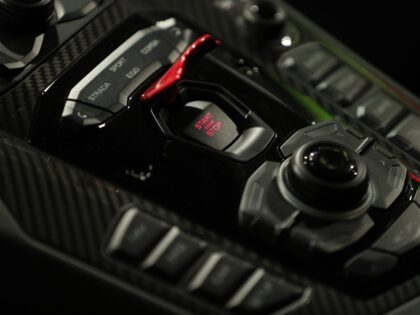 An engine start/stop button sits on a control panel inside a Lamborghini Aventador SVJ lux