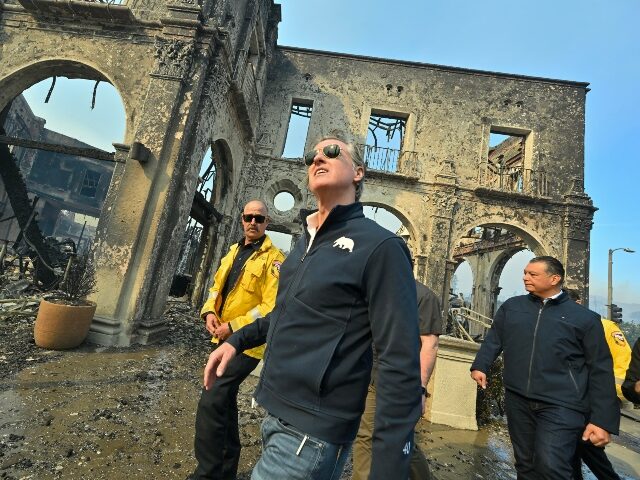 PCIFIC PALISADES, CA - January 08: California Governor Gavin Newsom, center, surveys damag
