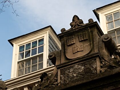 The Harvard University seal at an entrance to the campus in Cambridge, Massachusetts, US,