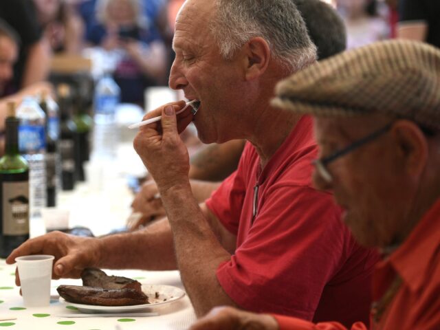 A man eats duck breast ('magret') in Saramon, southwestern France, on May 17, 2022 during