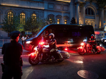 NYPD officer patrol a street after arresting some protesters during a "Defund the Pol