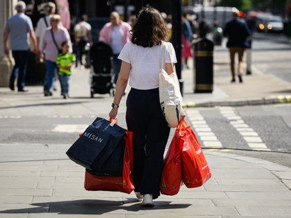 LONDON, ENGLAND - MAY 10: A shopper carries bags through the Oxford Street financial distr