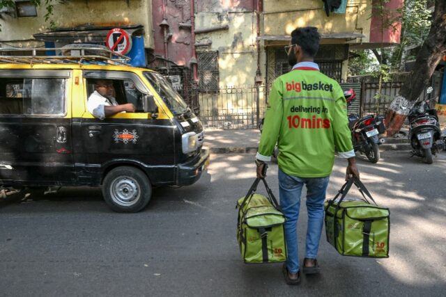 Armies of 'dabbawalas' crisscross Mumbai by foot and bicycle, delivering food to office wo