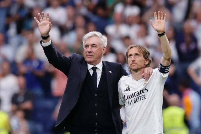 Coach Carlo Ancelotti and midfielder Luka Modric wave to fans at the end of Real Madrid's