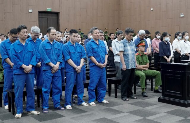 Defendants stand during their trial for illegal exploitation and exports of rare earths at