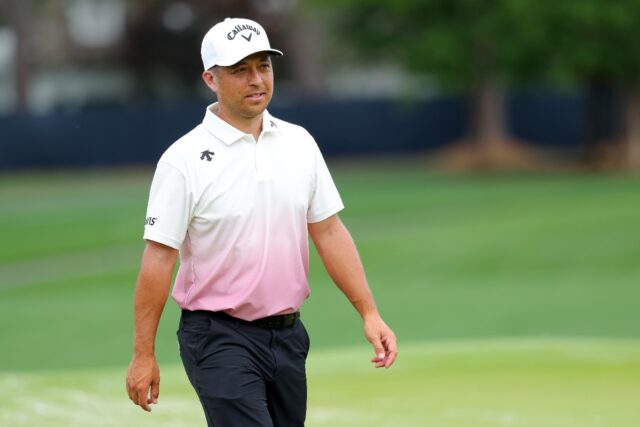 Defending champion Xander Schauffele of the United States walks on the fourth green during