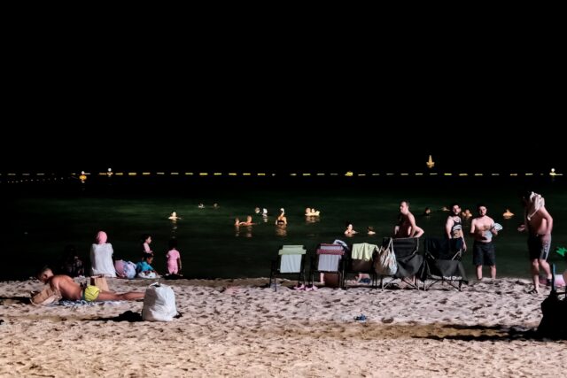 Dubai residents attempt to cool off at night at the Umm Suqeim beach as temperatures sizzl