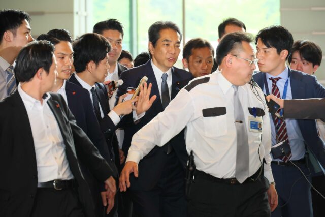 Farm Minister Taku Eto (C) told a gathering over the weekend that he had 'never bought ric