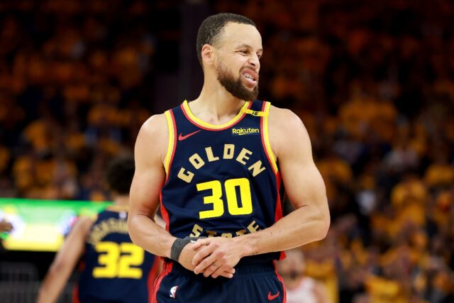 Golden State Warriors Stephen Curry holds his injured thumb during game four of the team's