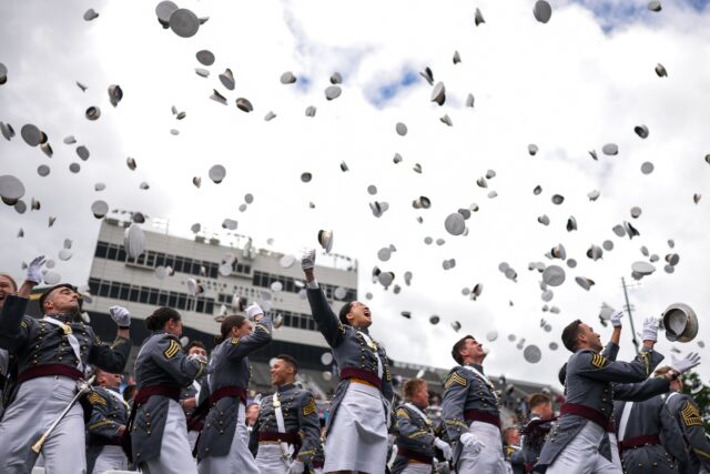 Graduates threw their hats into the air and marched accompanied by a military band